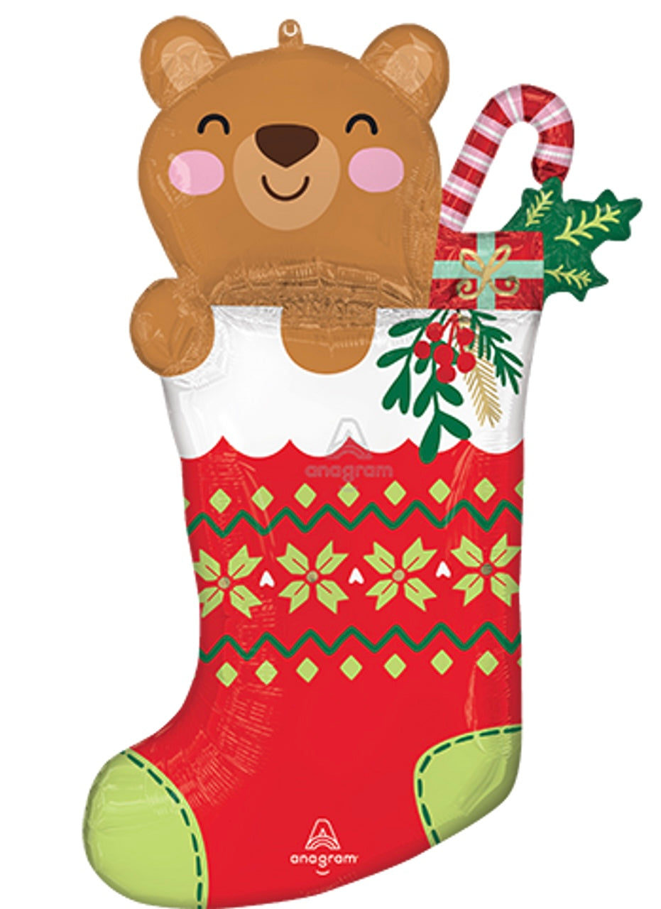 32-inch foil balloon shaped like a brown bear peeking from a red and white Christmas stocking with candy cane and holly.