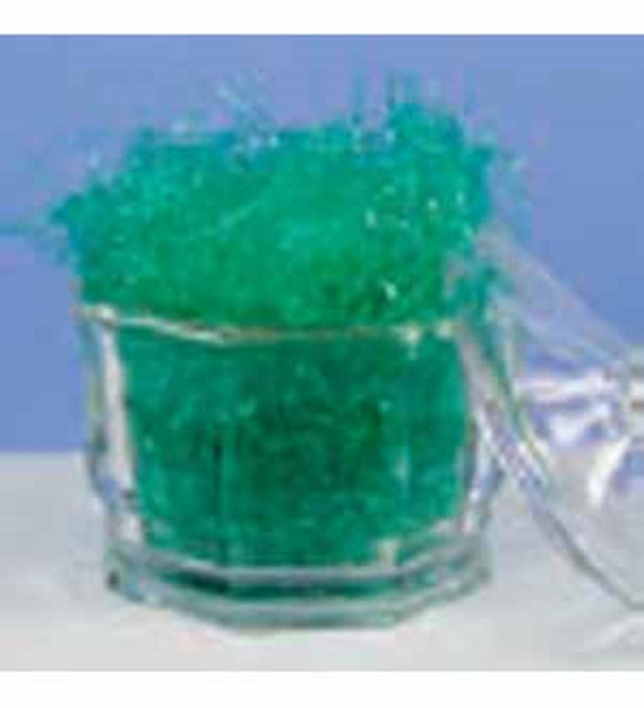 Small clear glass container filled with bright green decorative shredded grass, clear lid beside it.