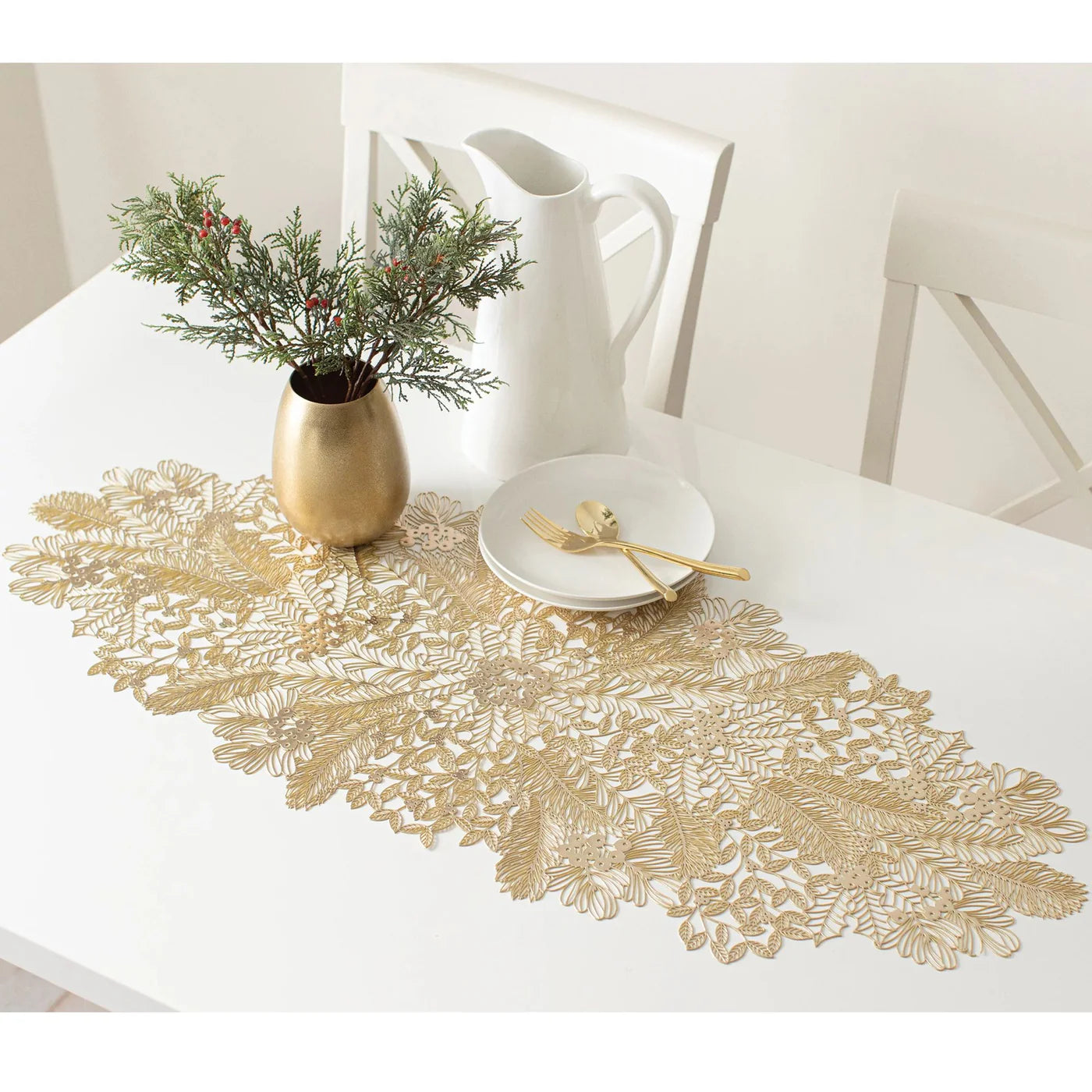 Gold lace-patterned vinyl table runner with intricate floral and leaf designs on white table.