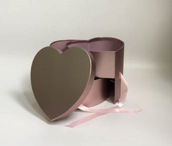 Pink heart-shaped gift box with matching ribbon and removable lid, matte finish.