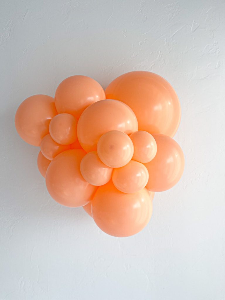 Tuftex Cheeky latex balloon color cluster showing the shade across multiple balloon sizes