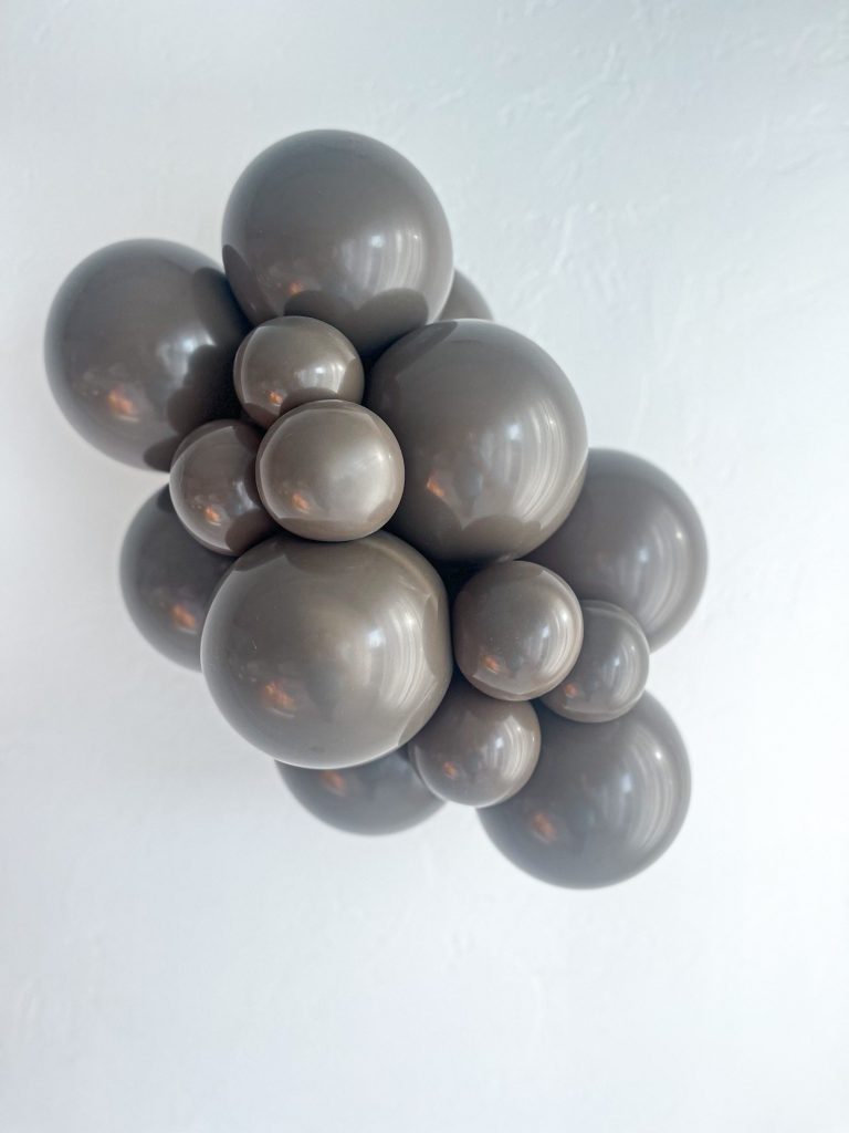 Tuftex Cocoa latex balloon color cluster showing the shade across multiple balloon sizes