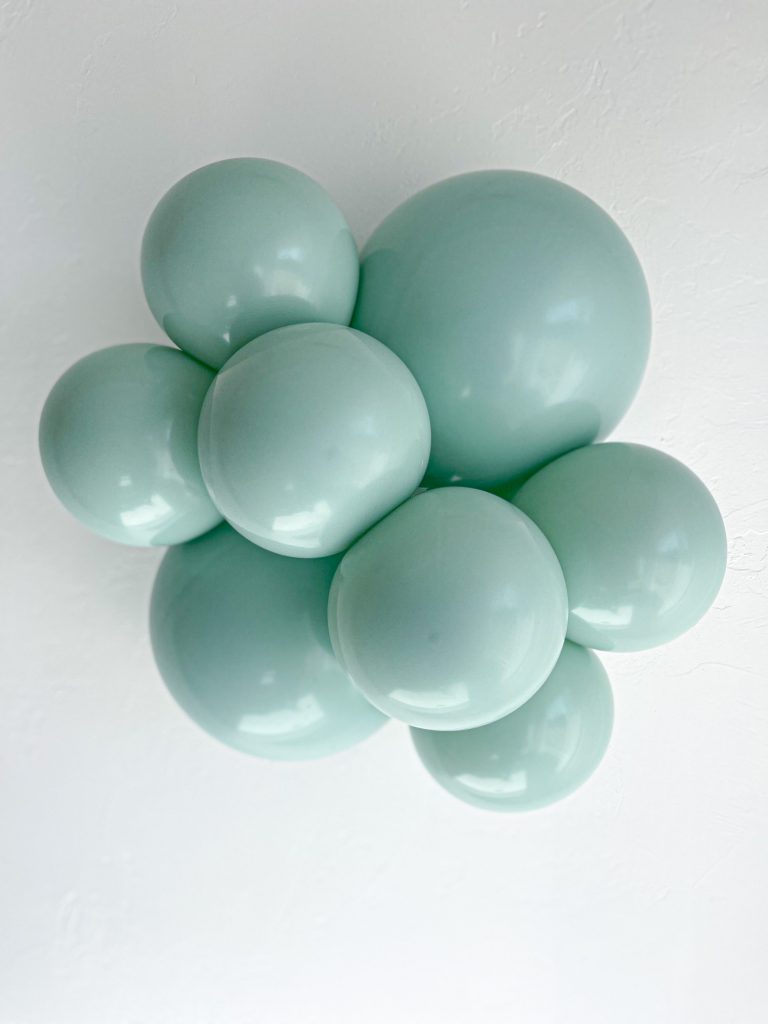 Tuftex Empower Mint latex balloon color cluster showing the shade across multiple balloon sizes