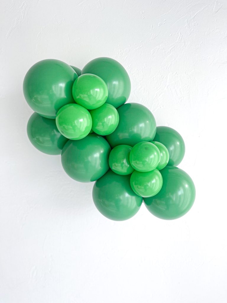 Tuftex Green latex balloon color cluster showing the shade across multiple balloon sizes