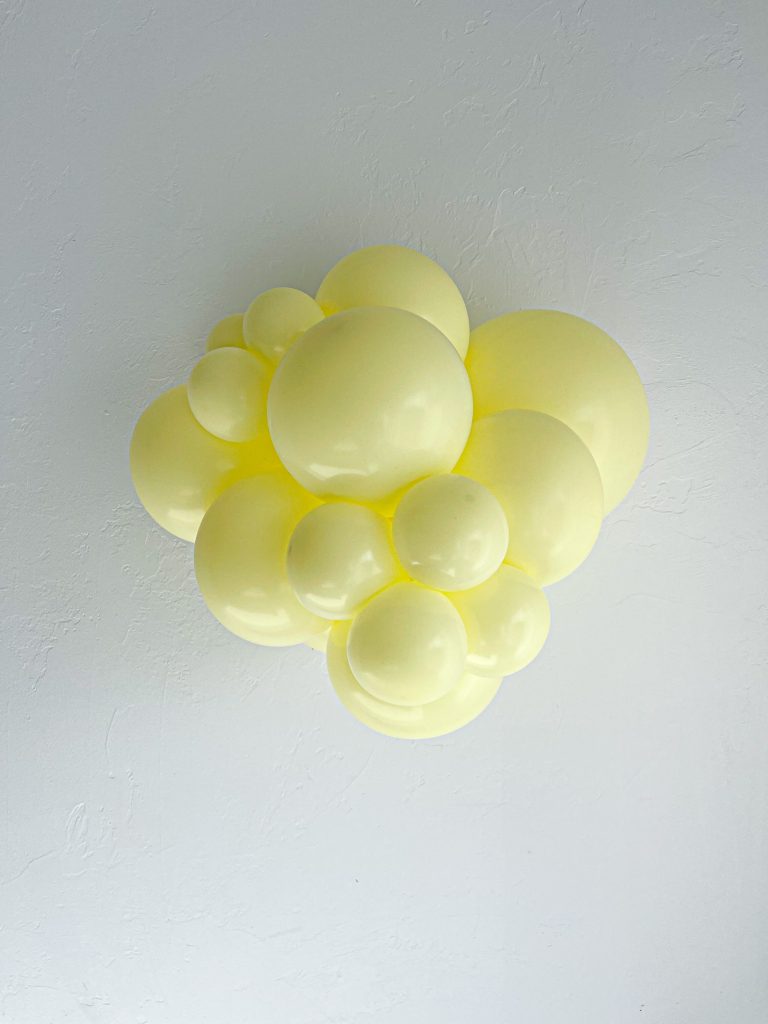 Tuftex Lemonade latex balloon color cluster showing the shade across multiple balloon sizes