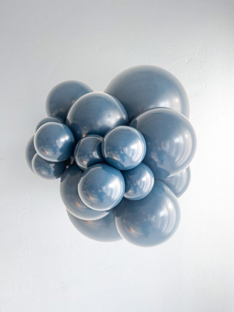 Tuftex Naval latex balloon color cluster showing the shade across multiple balloon sizes