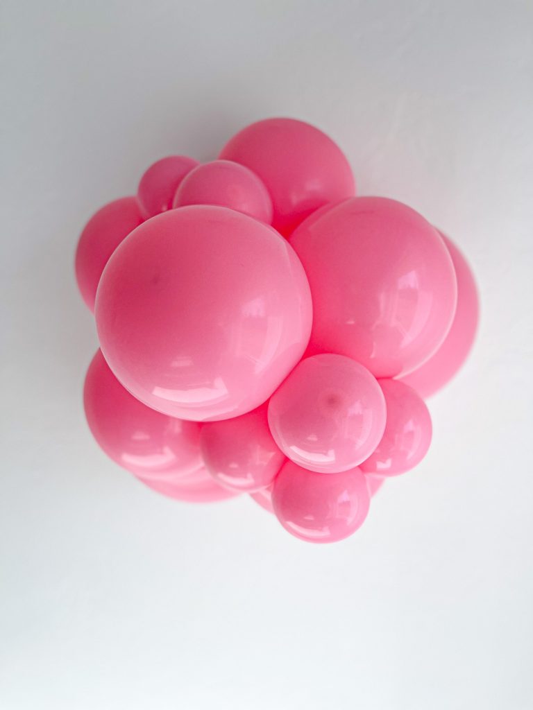 Tuftex Pink latex balloon color cluster showing the shade across multiple balloon sizes