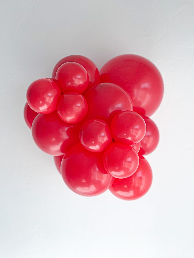 Tuftex Red latex balloon color cluster showing the shade across multiple balloon sizes