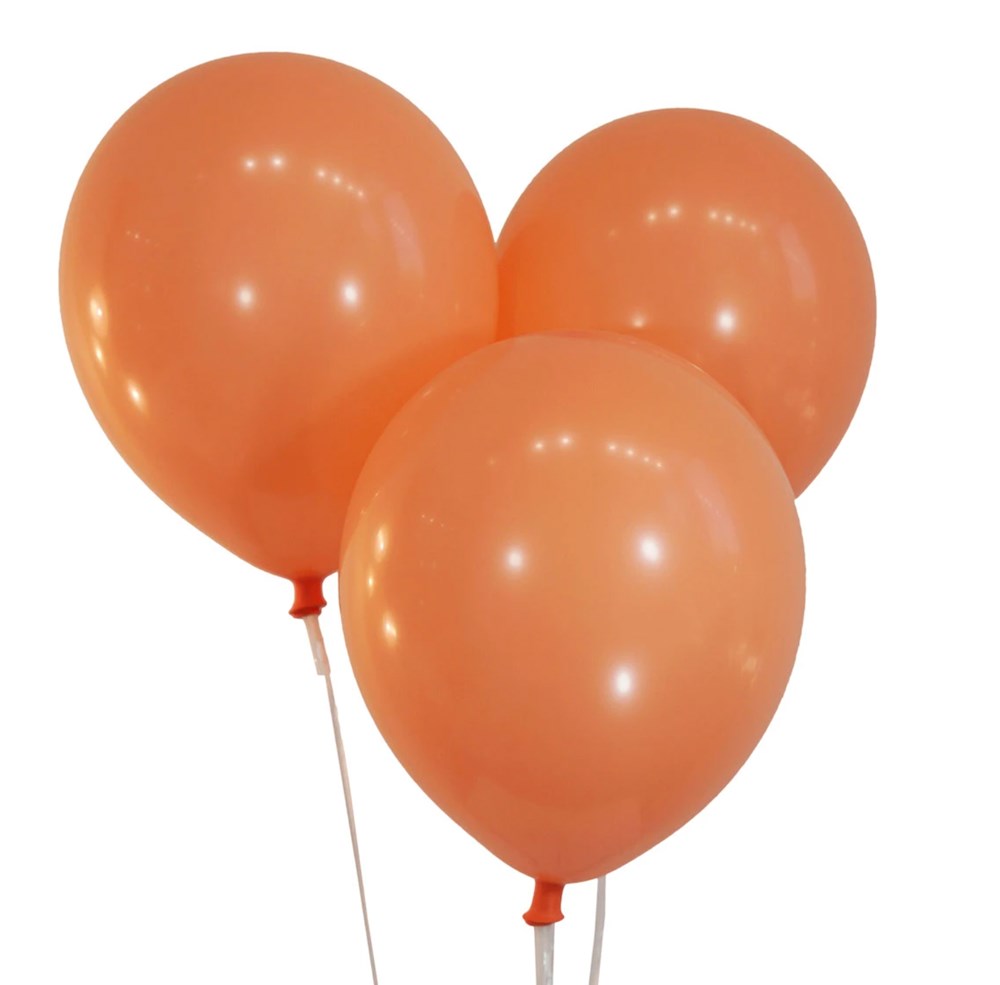 Three inflated round latex balloons in soft peach color with a smooth glossy finish.