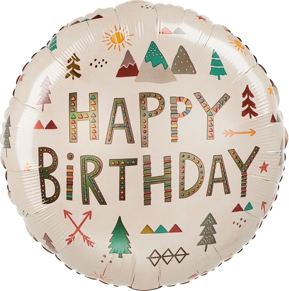 Round foil balloon with "Happy Birthday" in colorful patterned letters, decorated with trees, mountains, sun, and arrows on.