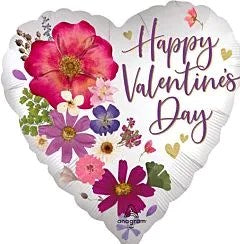 White heart-shaped foil balloon with pink, purple, and red pressed flower designs and "Happy Valentine's Day" in elegant.