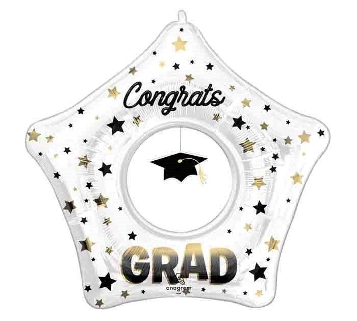 Star-shaped clear foil balloon with black and gold stars, "Congrats" text, graduation cap graphic, and "GRAD" in bold.