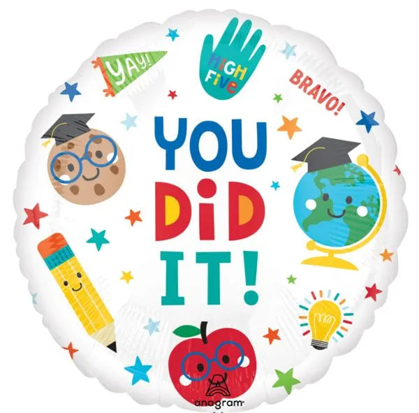 Round foil graduation balloon with colorful "You Did It!" text, decorated with cartoon apple, pencil, lightbulb, globe, and.