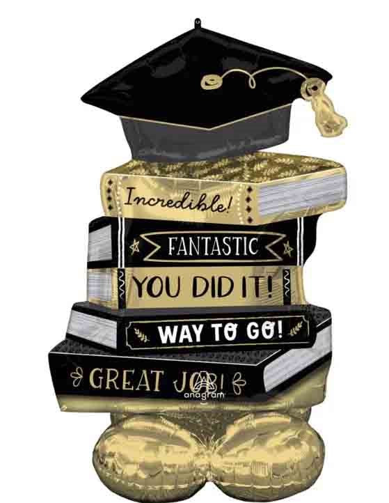 45-inch foil balloon shaped like a graduation cap atop stacked gold and black books with congratulatory text.
