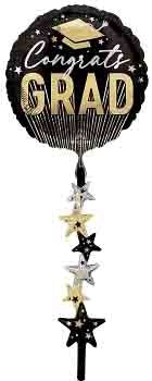 Round black foil balloon with gold "Congrats Grad" text and graduation cap, black and gold star tassel strings.