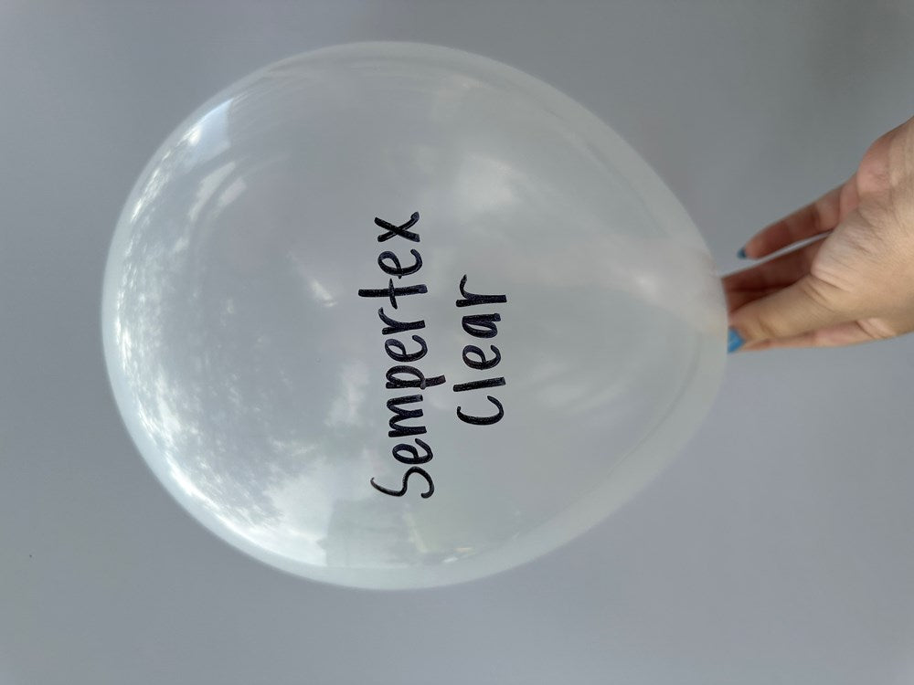 Transparent 5-inch latex balloon with "Sempertex Clear" printed in black, held by hand.