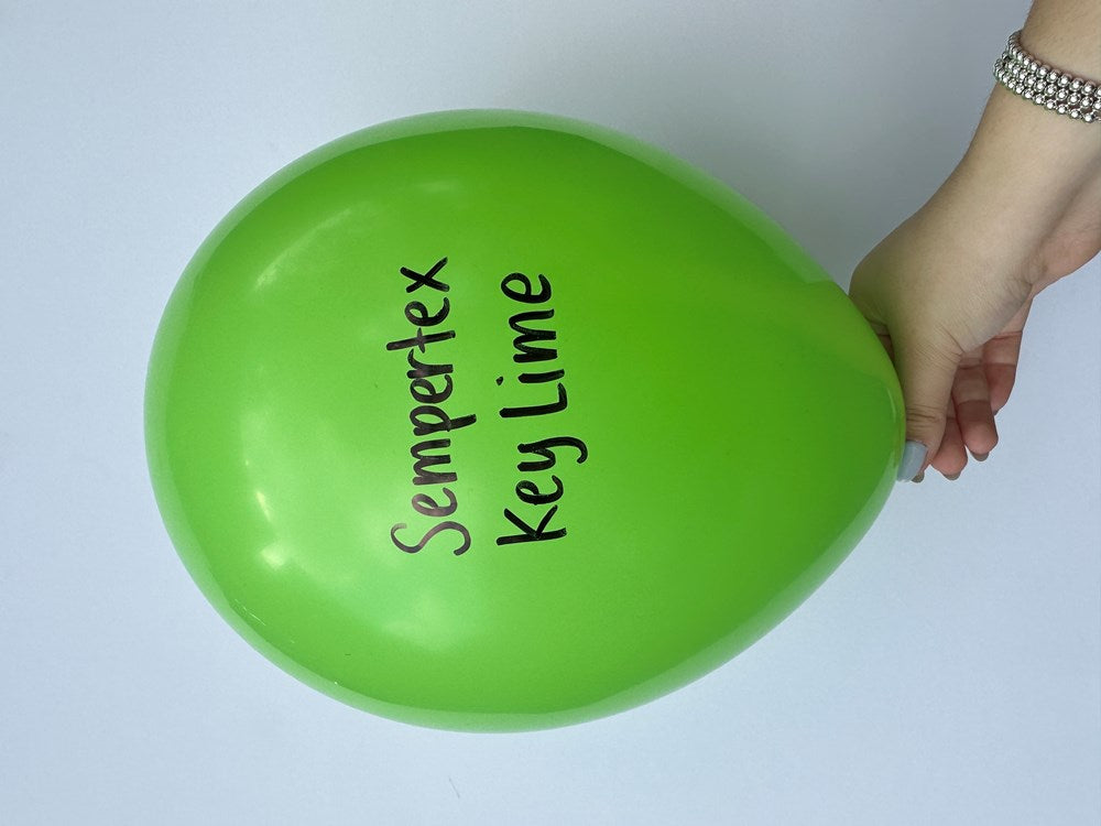 Bright key lime green latex balloon with "Sempertex Key Lime" printed in black, hand-held.
