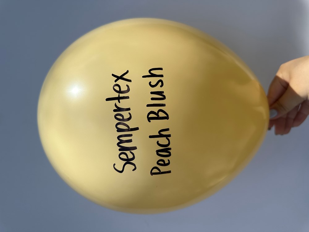Peach-blush 11-inch latex balloon with Sempertex branding, held against a light background.