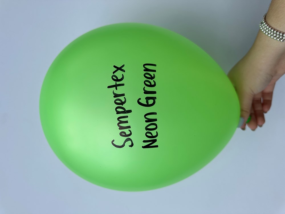 Bright neon green 11-inch latex balloon with black "Sempertex Neon Green" text, held by hand.