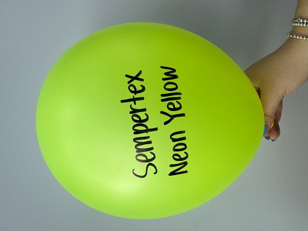 Bright neon yellow 11-inch latex balloon with black "Sempertex Neon Yellow" text, held by hand.