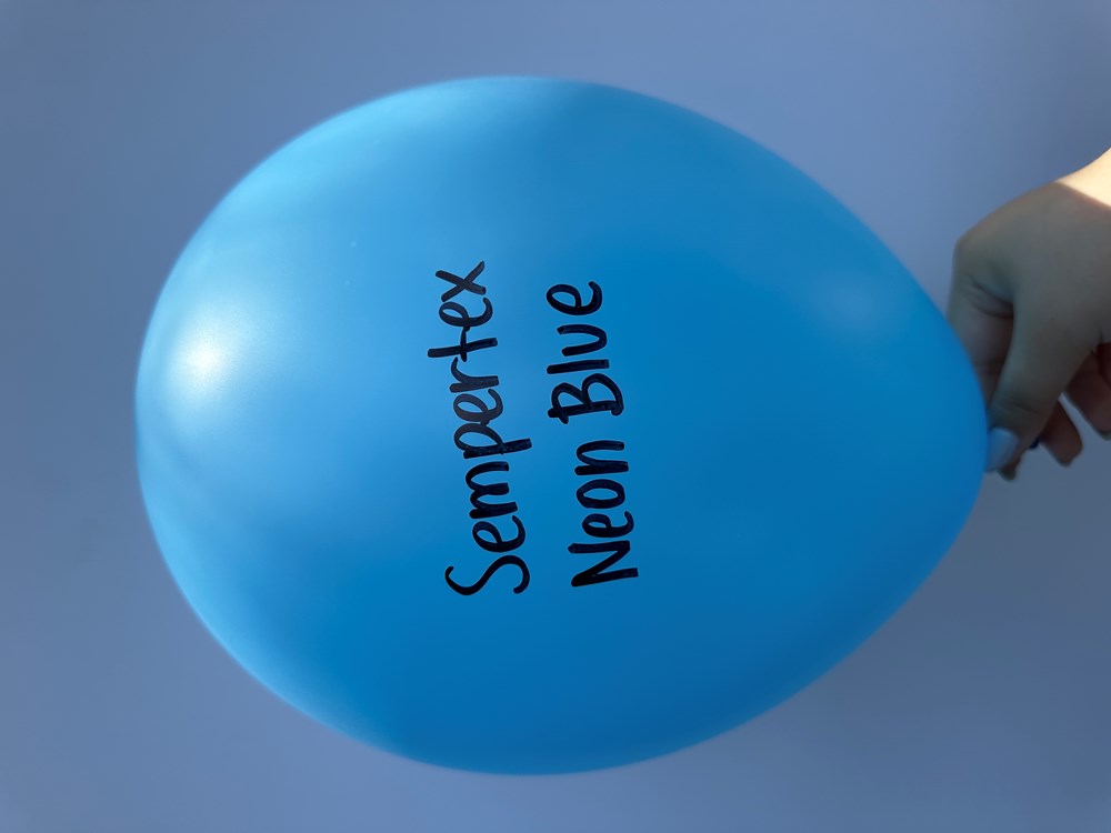 Bright neon blue latex balloon inflated, oval shape, with black "Sempertex Neon Blue" text printed vertically.