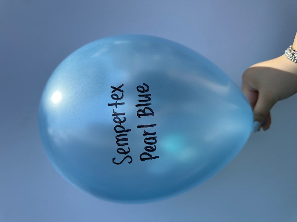 Glossy pearl blue 11-inch latex balloon with Sempertex Pearl Blue branding, held by hand.
