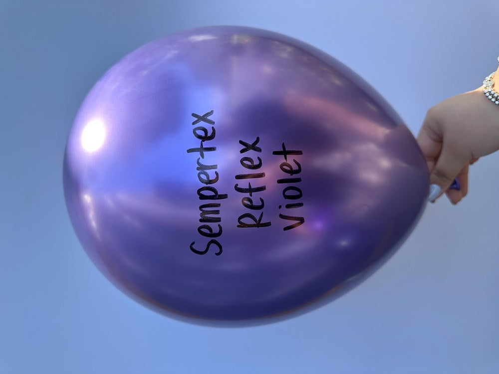 Shiny violet 11-inch latex balloon with Sempertex Reflex Violet text, held by hand.