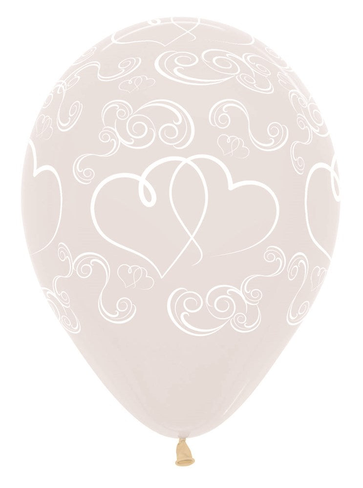 Clear latex balloon with white crossed heart and swirl designs, 11 inch round shape.