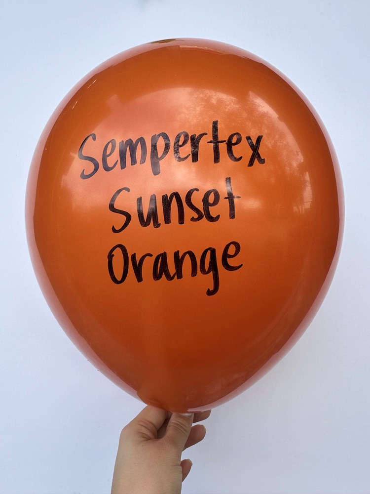 Glossy 18-inch round latex balloon in sunset orange with black Sempertex Sunset Orange text.