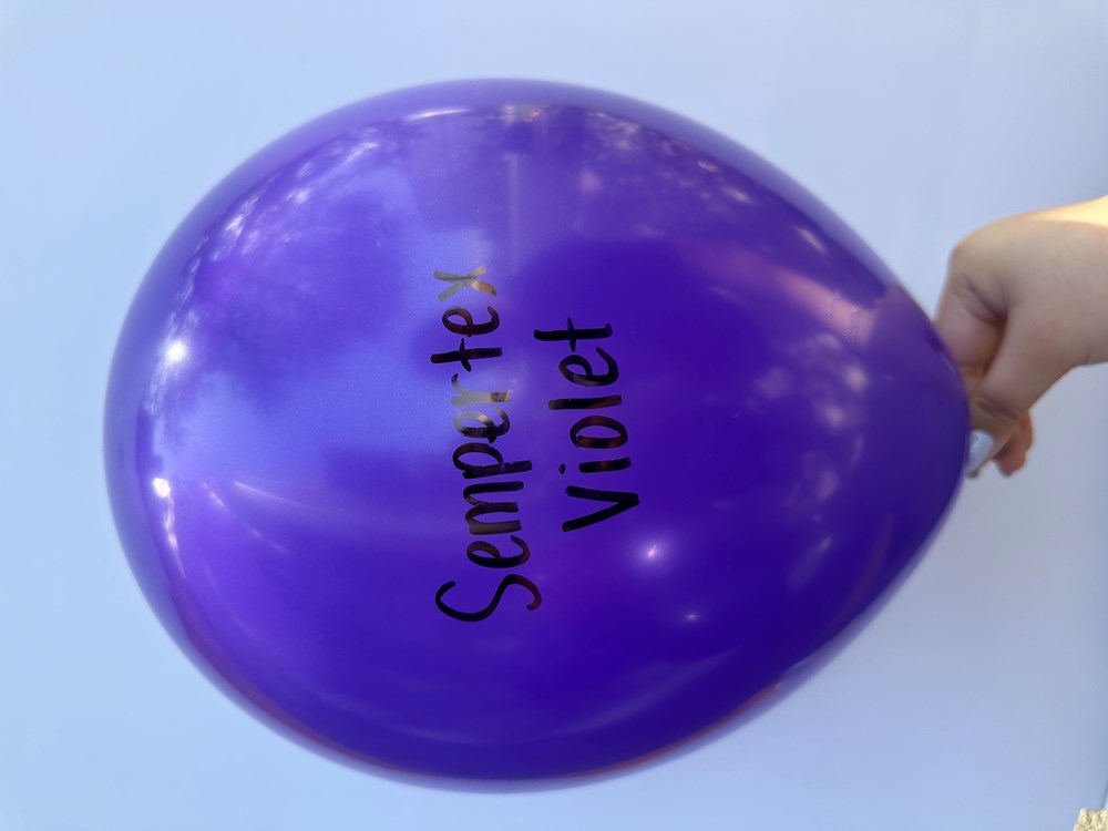 36-inch glossy violet latex balloon with "Sempertex Violet" printed in black, held by hand.