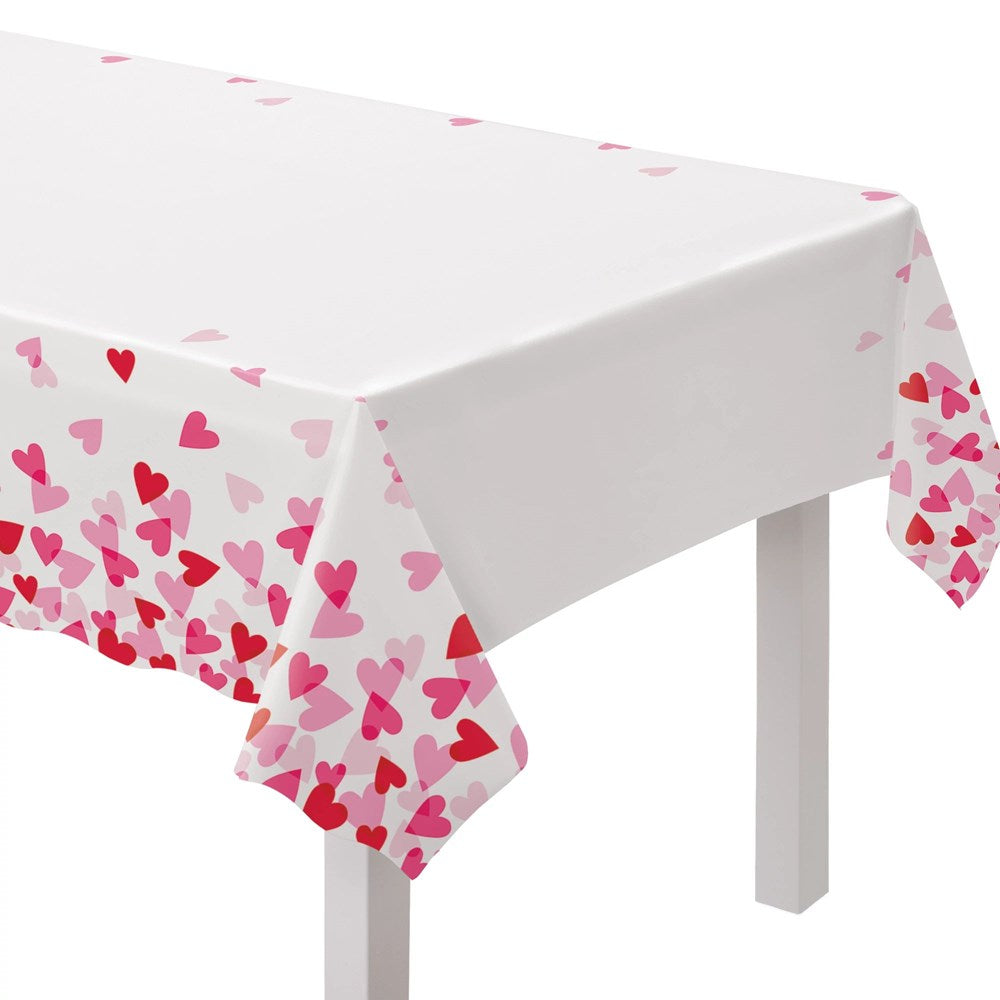 White rectangular table cover with scattered red and pink heart patterns along edges.