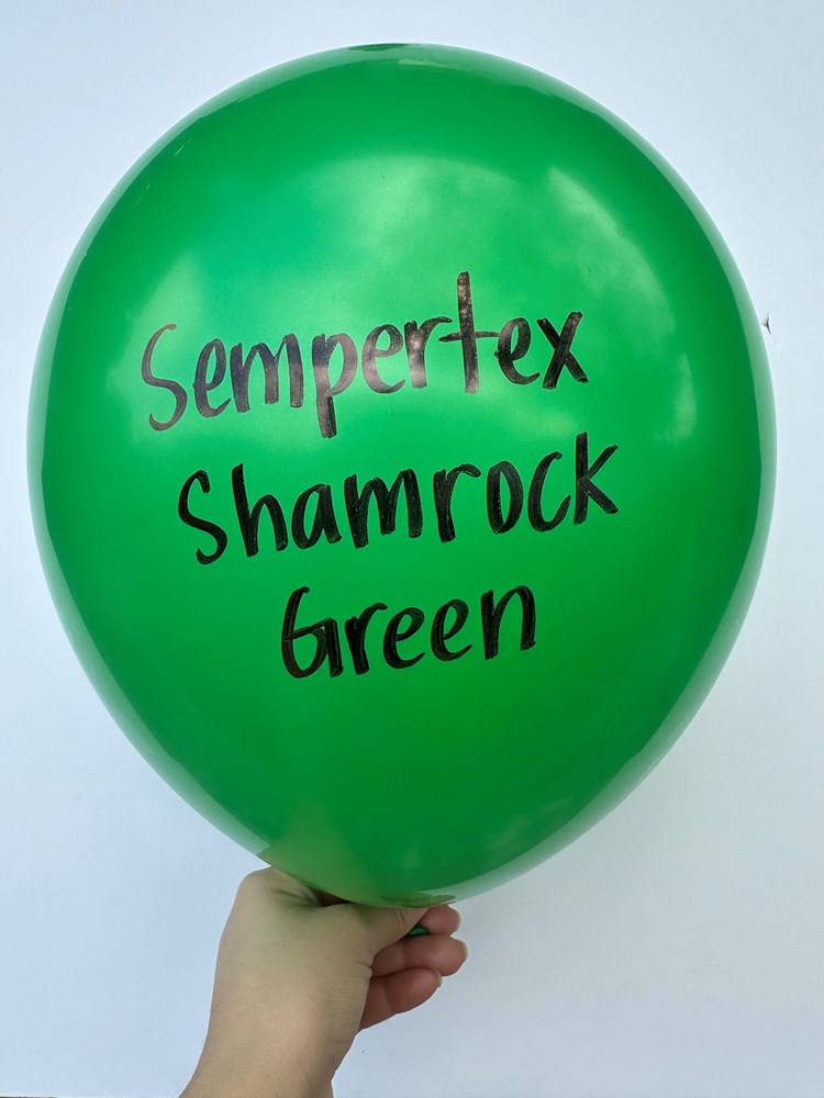 Glossy shamrock green latex balloon with black Sempertex Shamrock Green text, 24-inch round shape.
