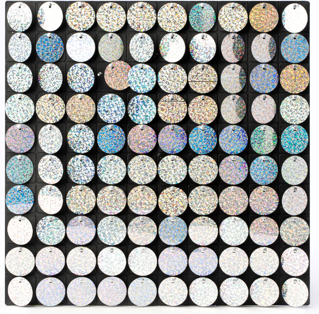 Square sheet covered in small circular holographic glitter elements creating a shimmering mosaic effect.