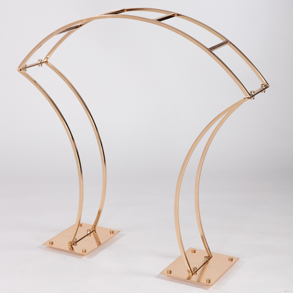 Gold metal table top arch with curved design, 37in high, 30in wide, and 7in deep.