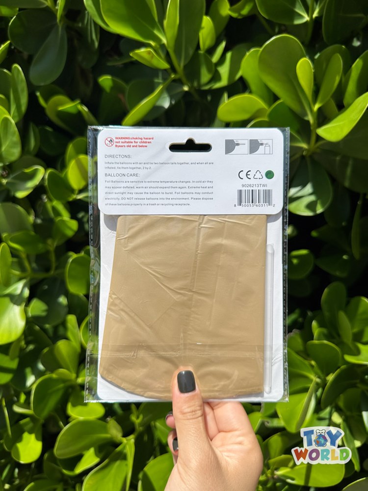 26-inch caramel-colored star burst foil balloon folded in clear packaging held outdoors.