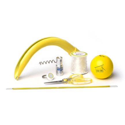 Yellow plastic banana-shaped tool with coil spring, spool of white thread, yellow tape measure, small yellow ball, scissors,