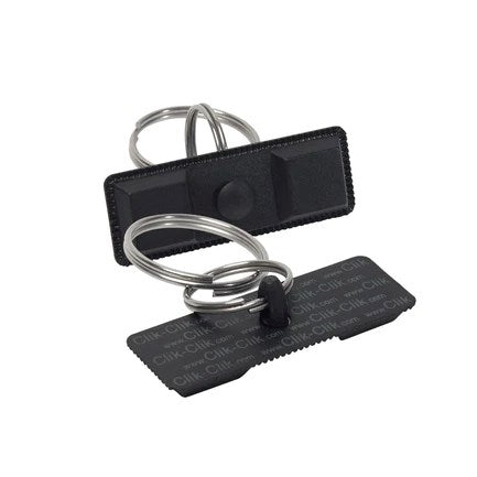 Black rectangular magnetic key holder with two metal key rings, textured surface, and Compact design.