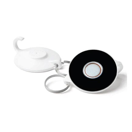 White round plastic retractable keychain with black circular center and metal keyring attached.