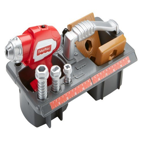 Red and grey plastic toy drill with black base holding toy bolts and a brown toy hand saw, all part of a children's tool set.