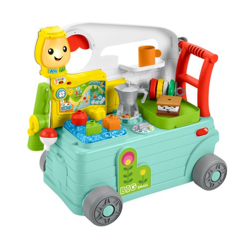Colorful plastic baby toy shaped like a teal camper with yellow sun character, red handle, and interactive buttons and.