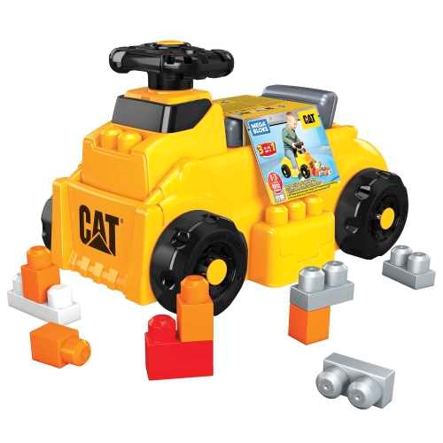 Yellow and black plastic CAT ride-on toy with Mega Bloks building pieces attached and scattered around.