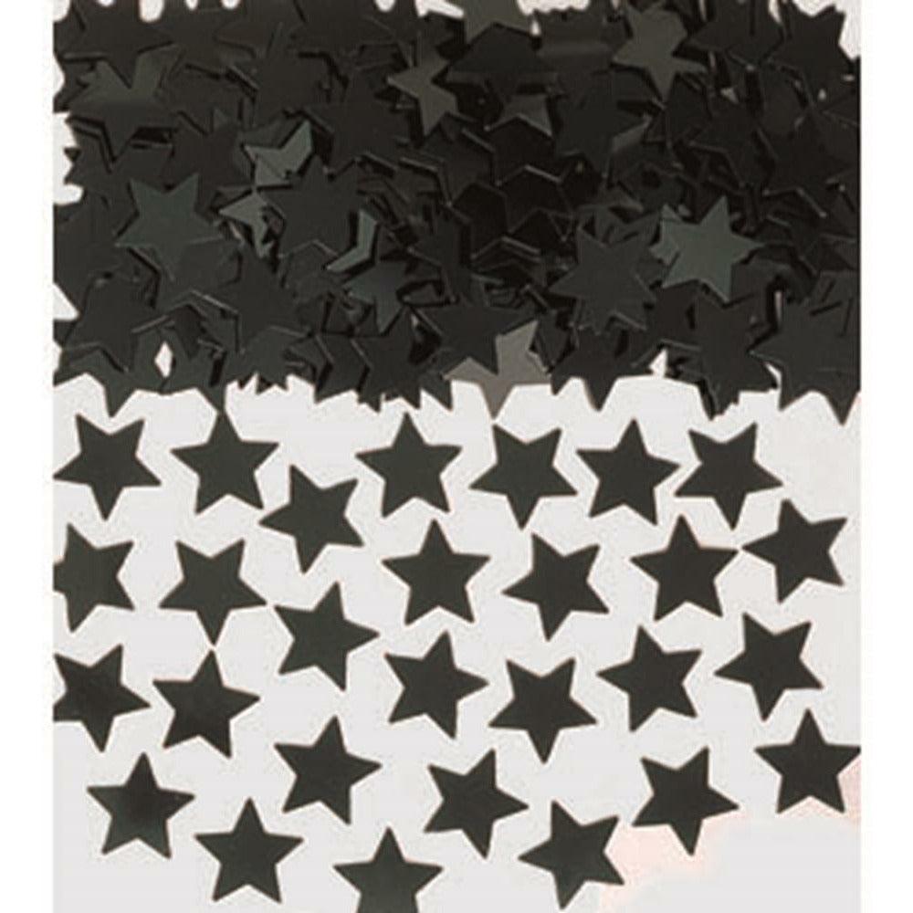 Black mini star-shaped confetti scattered on a white surface.