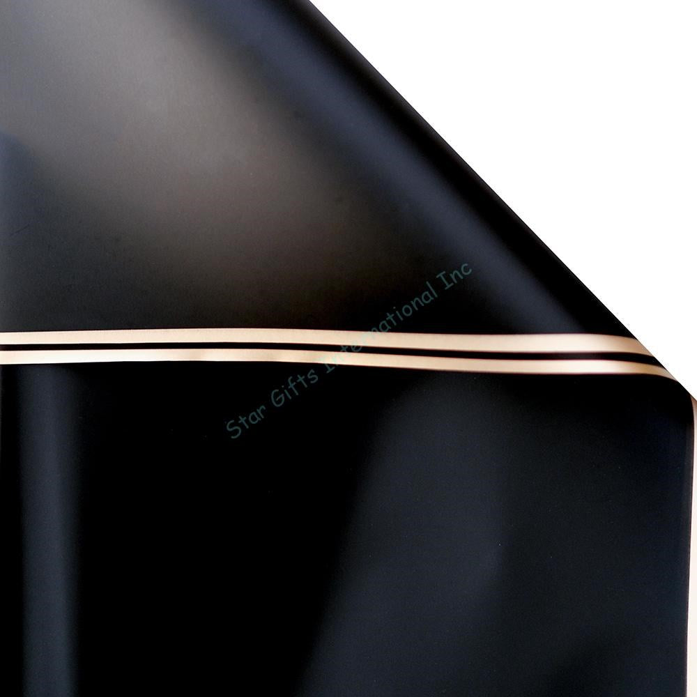 Black wrapping paper with a smooth matte finish and thin gold metallic edges, rolled sheet style.