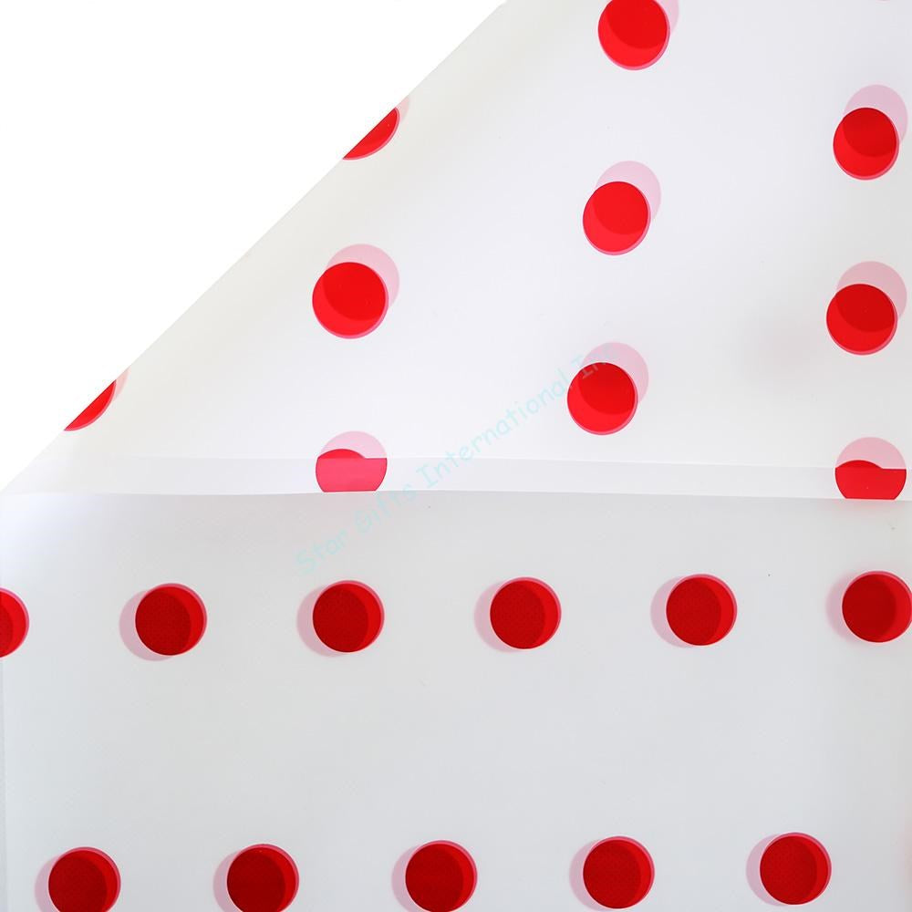 White translucent wrapping paper with evenly spaced solid red dots.