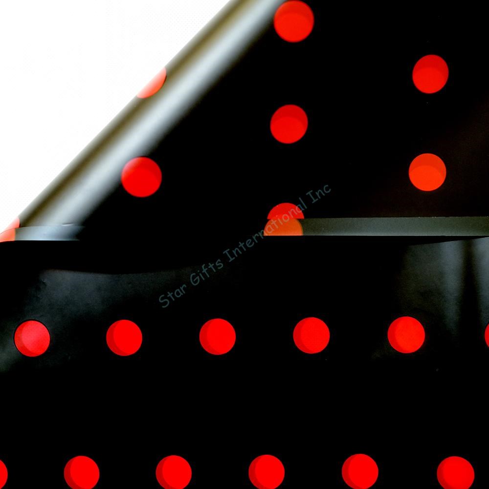 Black wrapping paper with evenly spaced bright red polka dots in a glossy finish.