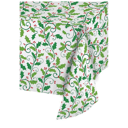 White plastic tablecover roll with green holly leaves and red berries pattern.