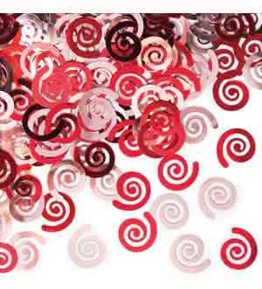 Red and pink swirl-shaped confetti pieces scattered on a white background.