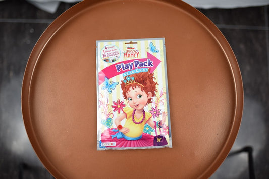Rectangular colorful play pack featuring a cartoon girl with red hair and floral decorations on a white background.