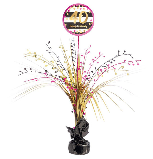 Pink and gold spray centerpiece with "40" birthday topper and black foil-wrapped base.