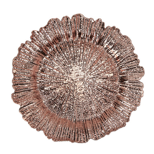 Rose gold plastic charger plate with textured, scalloped reef-inspired edges and a shiny finish.